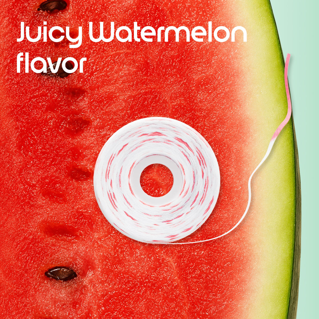 A roll of white dental floss with pink and white twisted strands, placed on a slice of watermelon next to a mint green background. White text in the top left reads 'Juicy Watermelon flavor'.