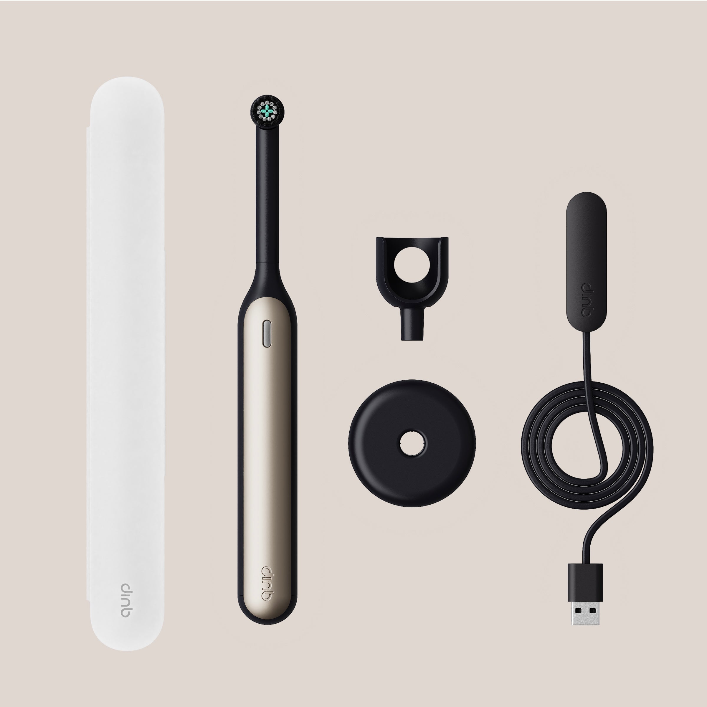 Quip electric toothbrush set with handle, head, and cable on a beige background