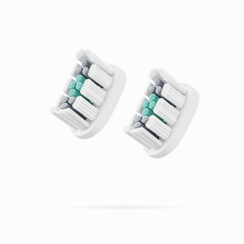 Two toothbrush heads with a striped pattern on a white background
