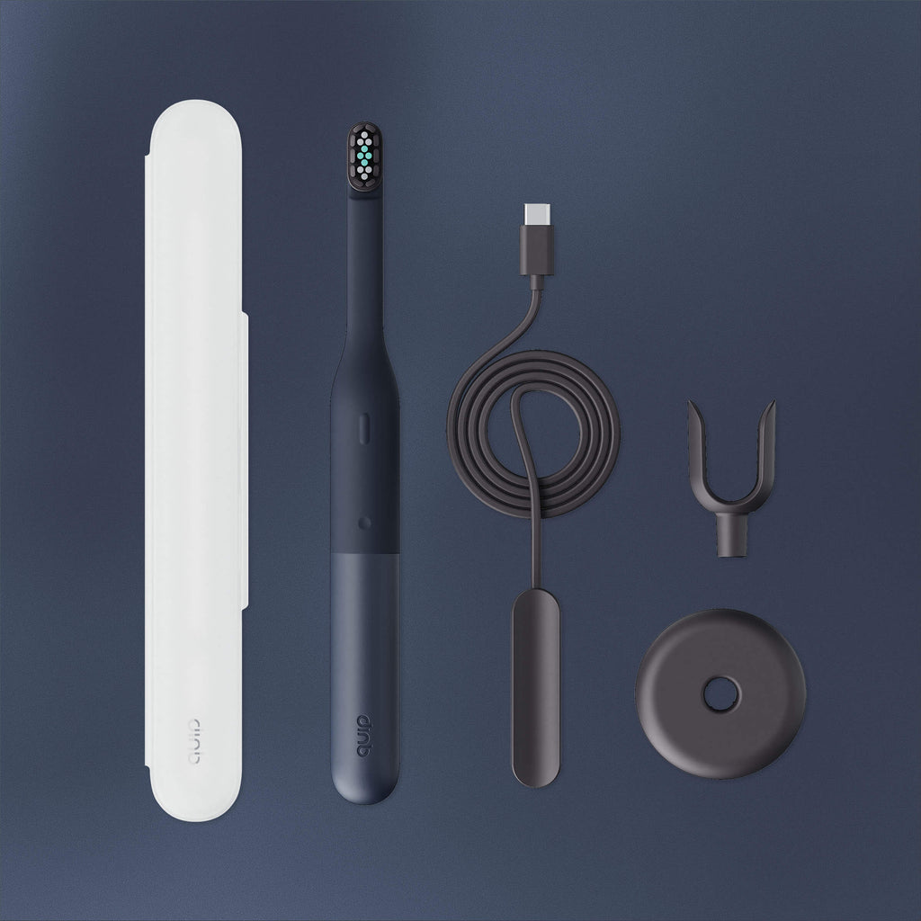 Collection of dental care products including a toothbrush, charger, and accessories on a dark background