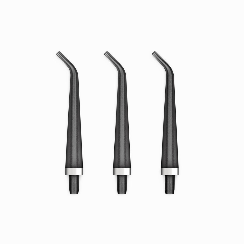 Three black dental nozzles with silver bases on a white background