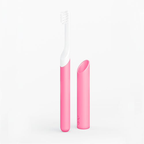 A pink sonic toothbrush with a glowing handle and a small soft-bristle brush head, displayed alongside its radiant travel cover, against a white background.