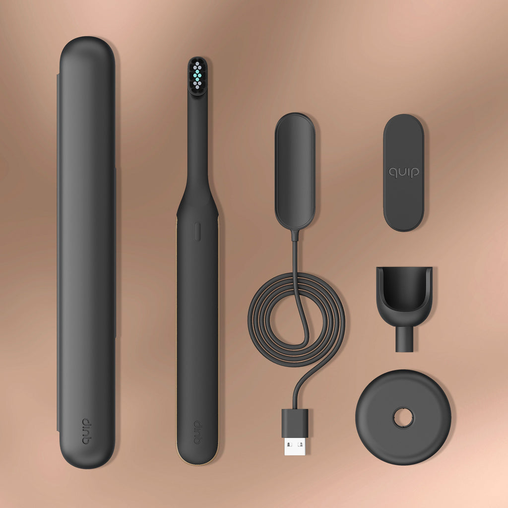 Flat lay of the Ultra™ Next Generation Smart Sonic Electric Toothbrush in Eclipse color, showing all included components: toothbrush, travel cover, magnetic charging cable, wall mount, and charging stand.