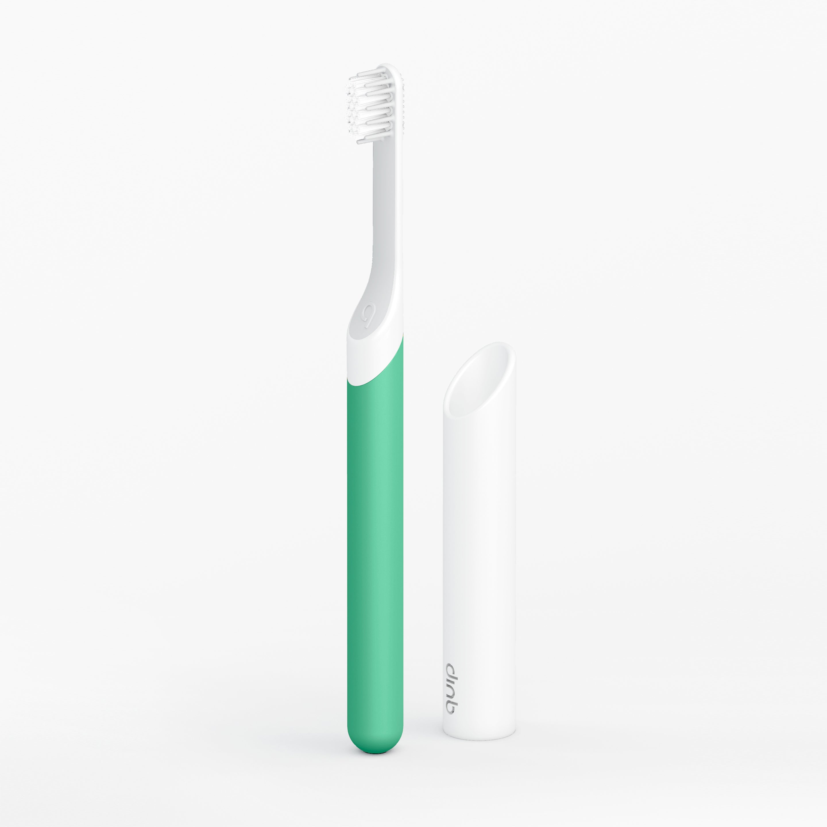 Green and white toothbrush on a light gray background