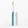 Blue and white toothbrush with a white holder on a light gray background