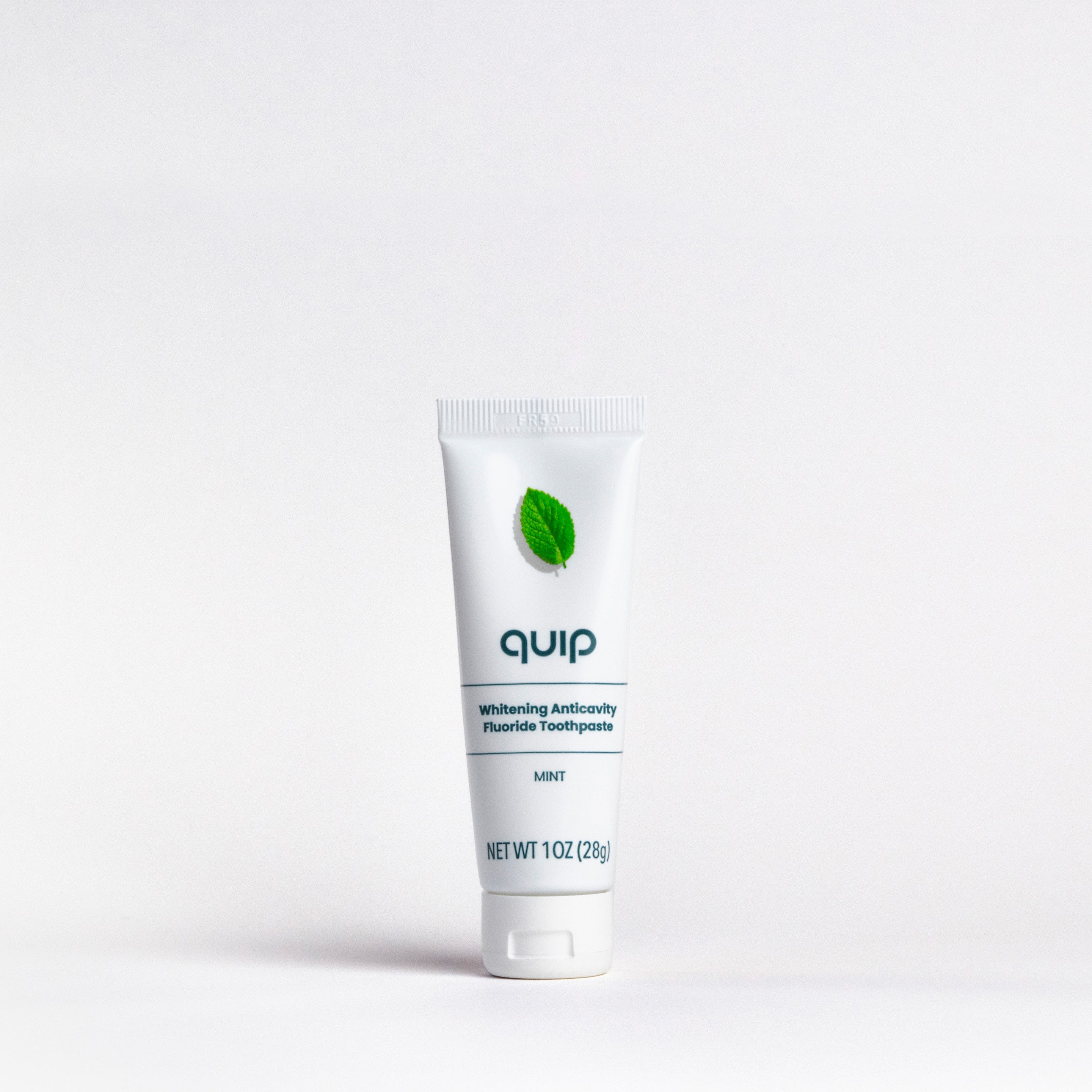Tube of 'quip' toothpaste on a white background