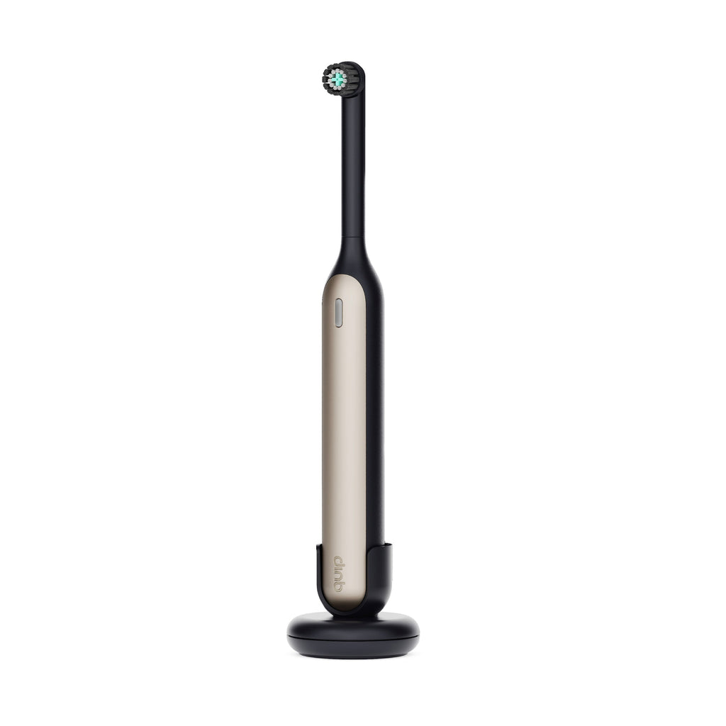 Black and silver electric toothbrush on a white background