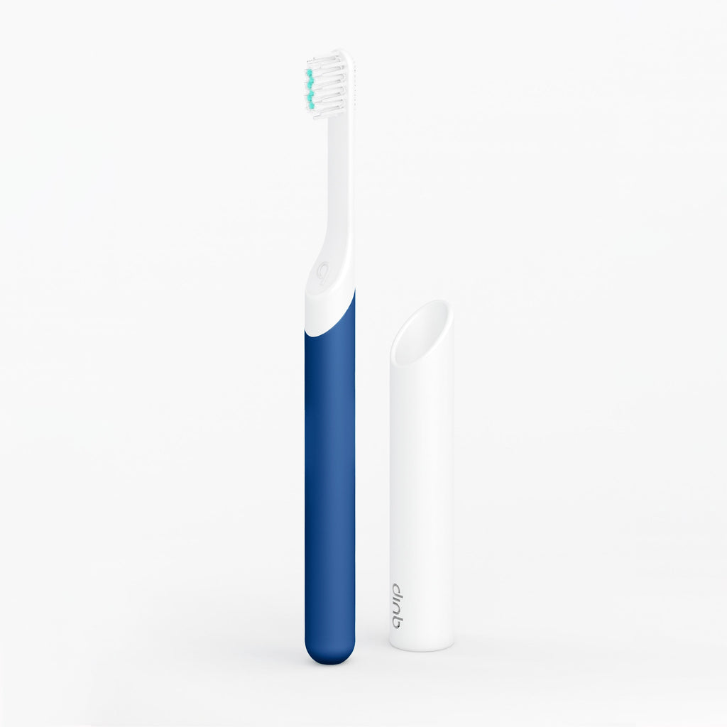 An image showing a kids sonic toothbrush with a blue handle and white body, alongside a travel cover or mount.