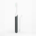 Black and white electric toothbrushes on a white background