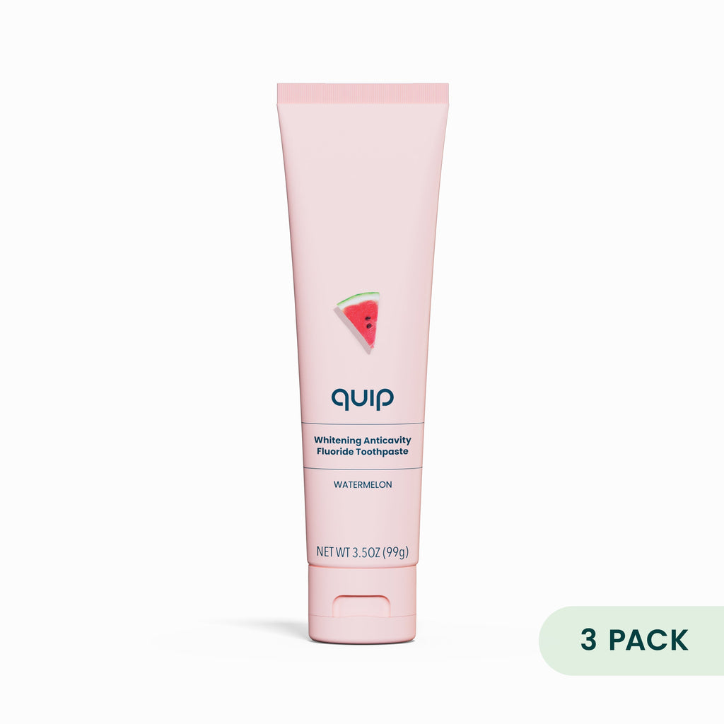 Pink toothpaste tube with watermelon flavor label on a white background