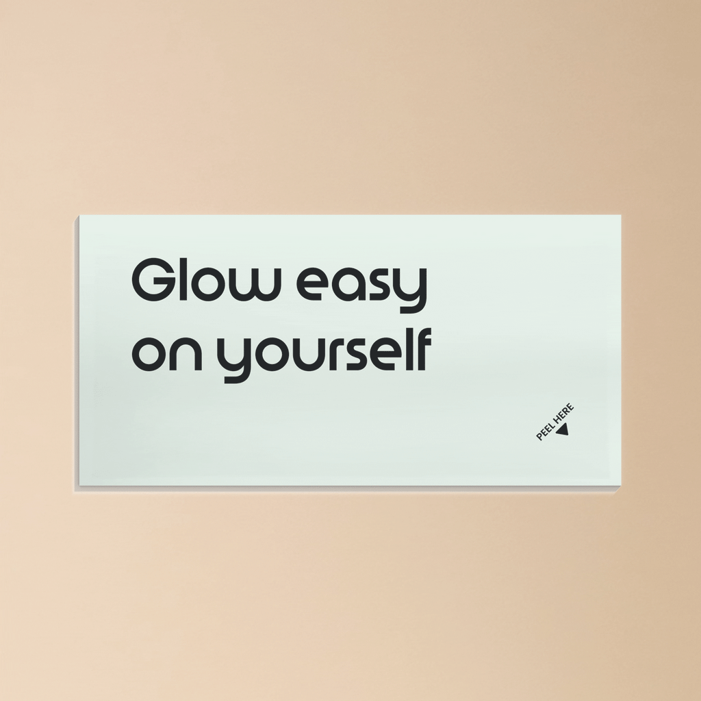 Light card with the text ‘Glow easy on yourself’ against a soft beige background.