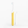 A kids sonic toothbrush with a yellow handle and white brush head, displayed alongside its travel cover/mount.