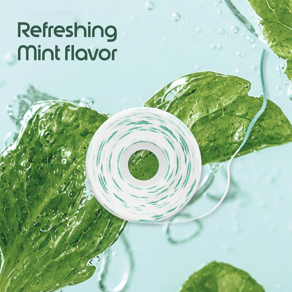 A roll of mint-flavored dental floss is shown on a light aqua background with green mint leaves and water droplets. The text 'Refreshing Mint flavor' appears in the upper left.